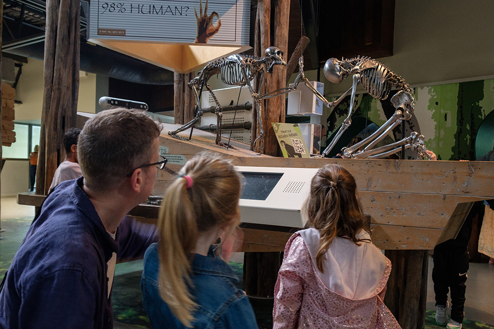 Visitors – adult male and two female children – looking at an exhibit within the Budongo trail IMAGE: Robin Mair 2022